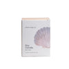 Shore Soap Co. soy candle packaging with a shell design on a light gray background