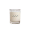 Candle in a glass jar with wavy design on a light gray background